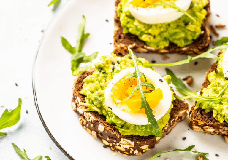 Avocado-Toast mit Ei und Rucola